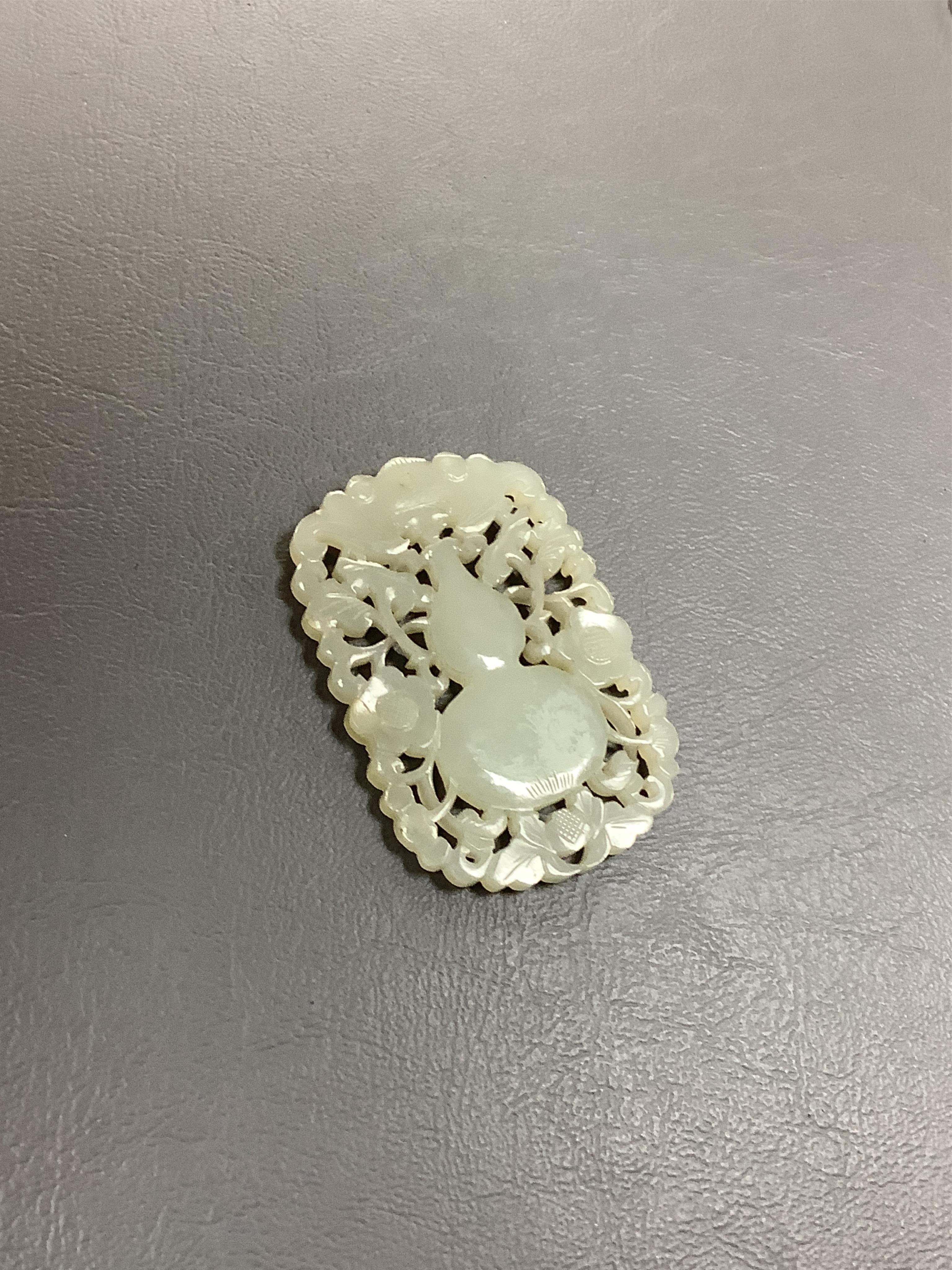 A carved jade/nephrite 19th century carving, 6cm long. Condition - good